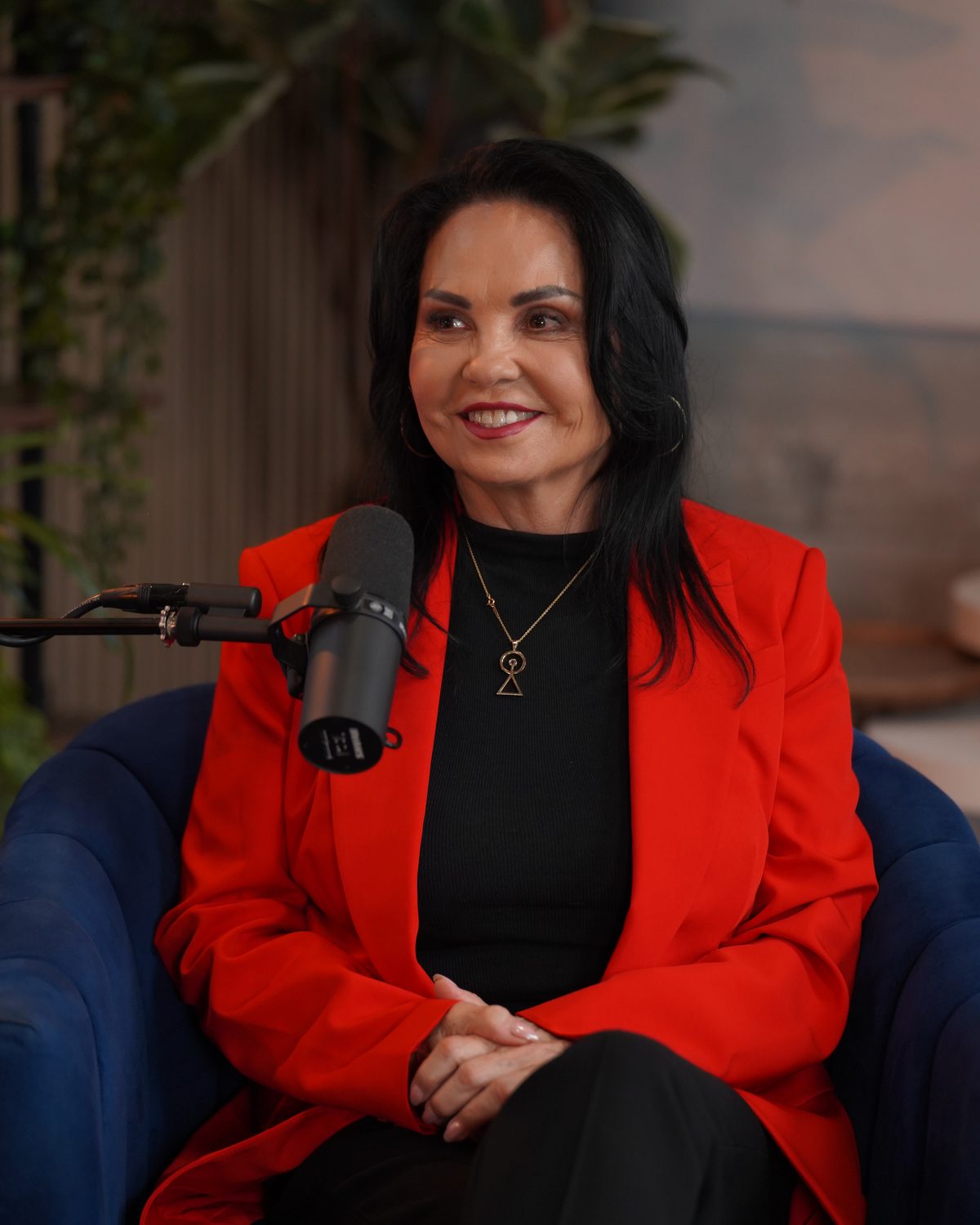Olivia Ramirez Smith in conversation, wearing a red blazer